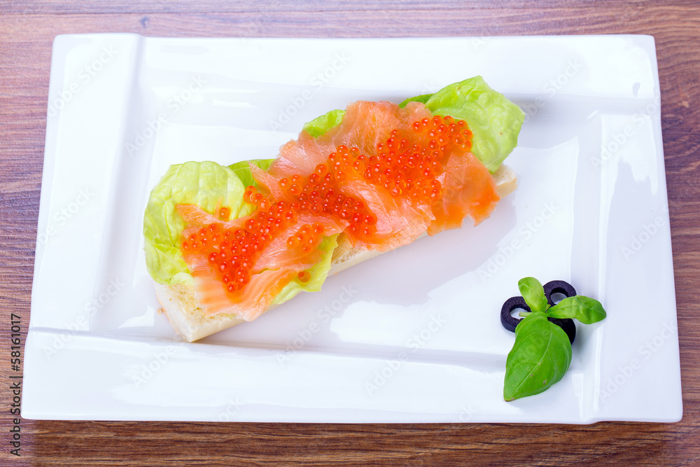 Red caviar and smoked salmon sandwich