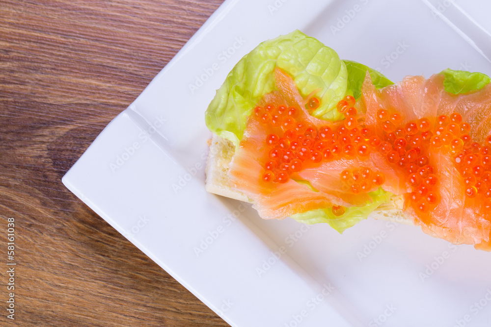 Red caviar and smoked salmon sandwich