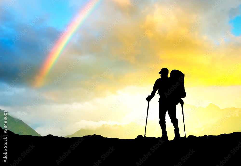 Silhouette of a tourist on the mountain top.