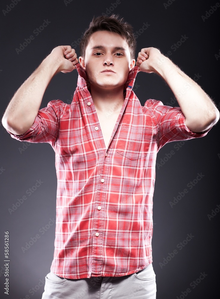 Portrait of casual young man in red checkered shirt