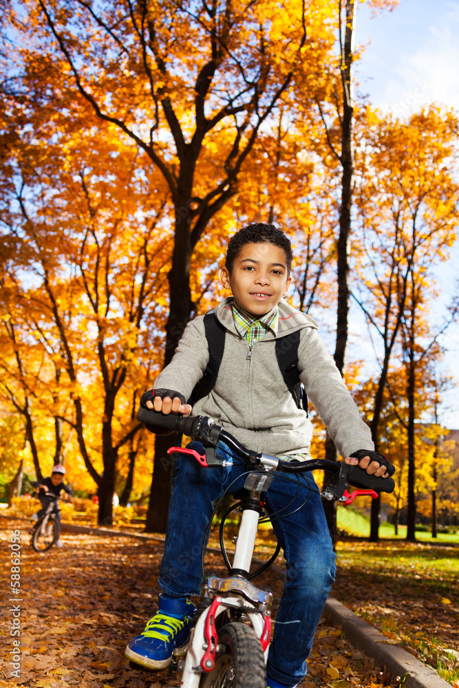 Kids on a bike in autumn park