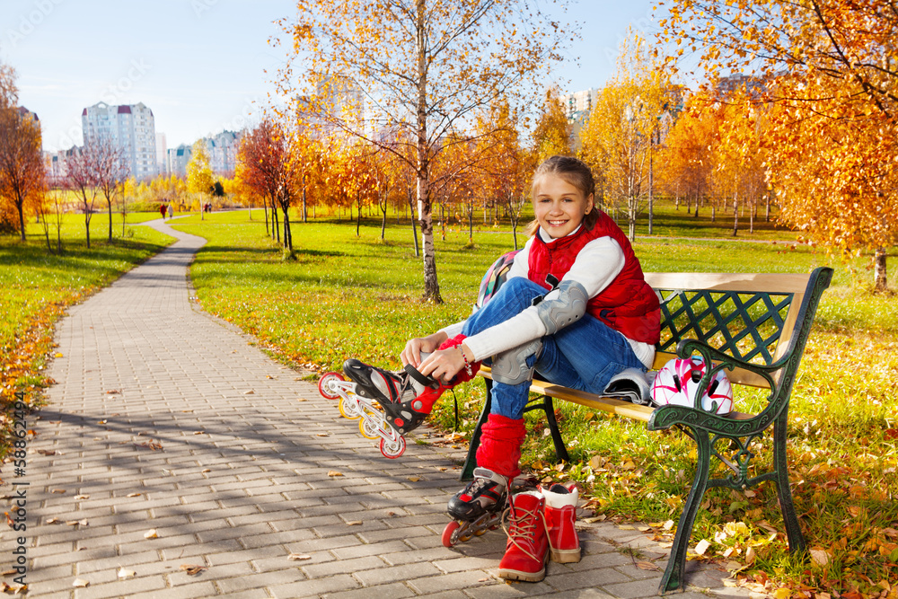 Cute girl putting on roller blades