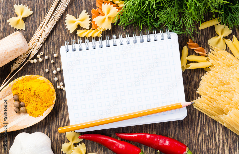 spices and vegetables around notebook