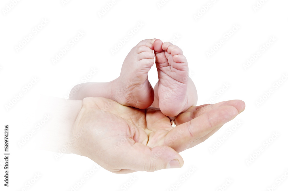 Babys foots in father hands on the monochrome background