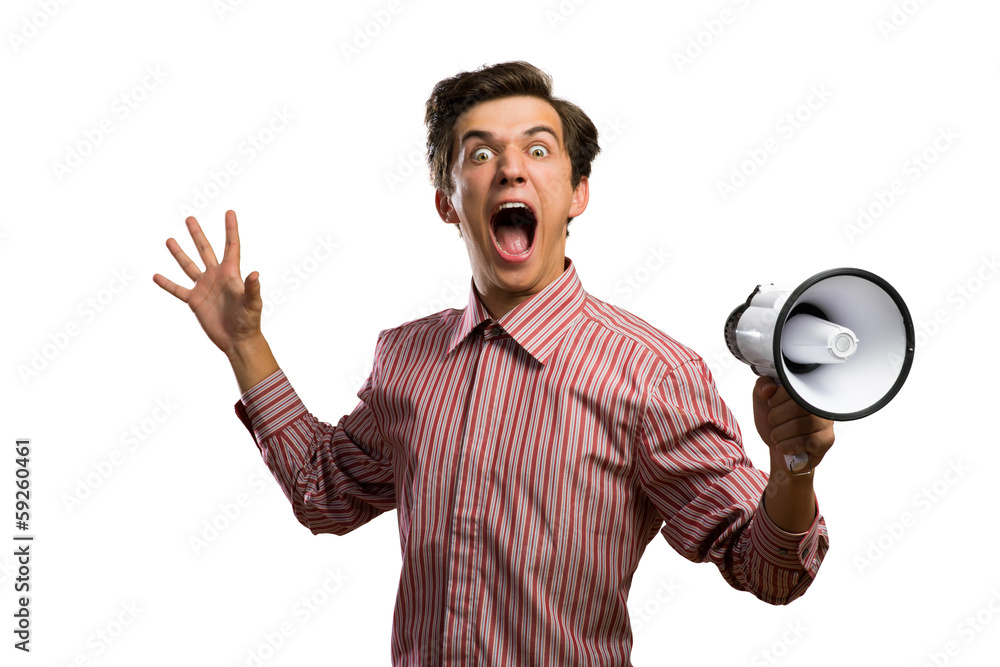 Portrait of a young man shouting using megaphone