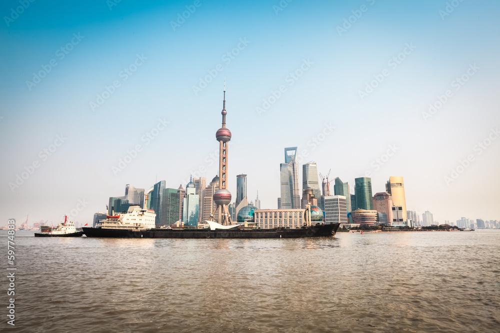 shanghai skyline and cargo ship