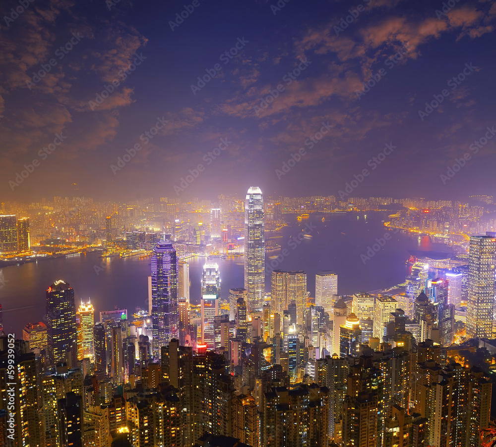 Hong Kong city skyline panorama at night with Victoria Harbor an