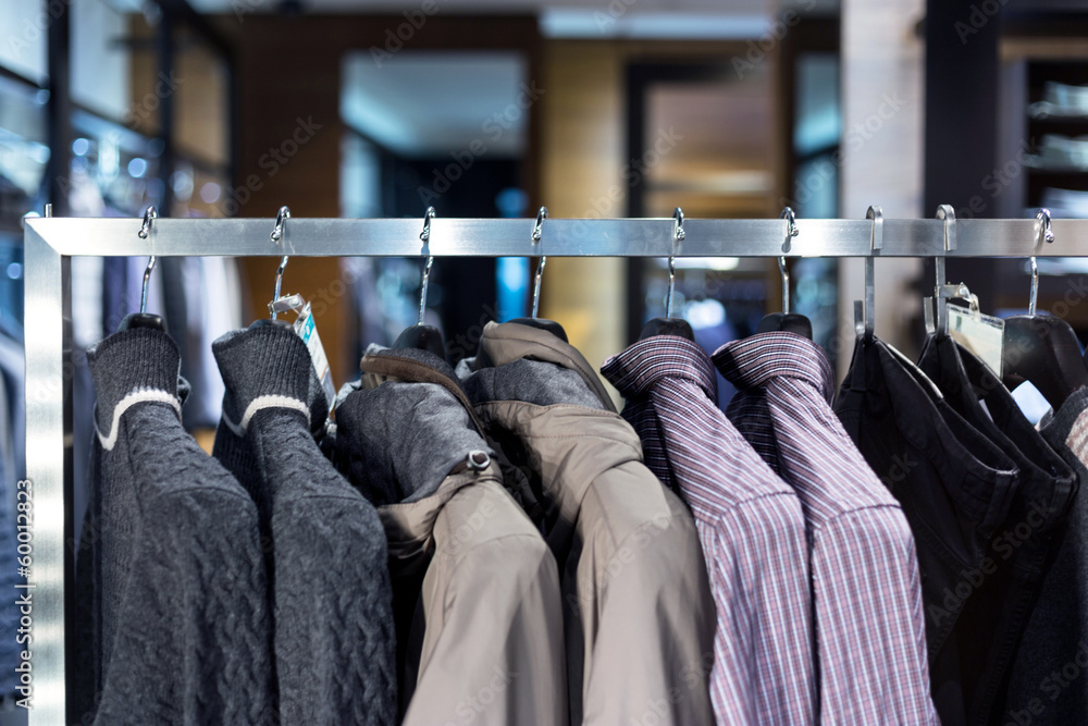 Row of men suits hanging in closet.