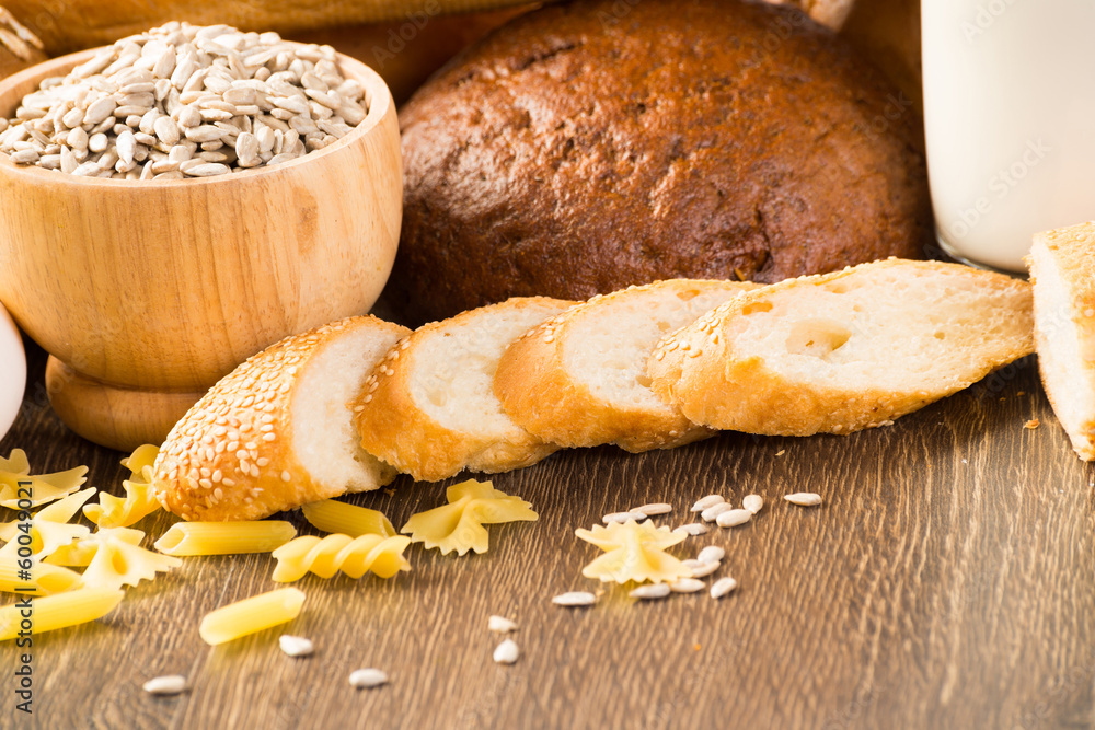 Fresh bread, eggs and glass of milk and grains.