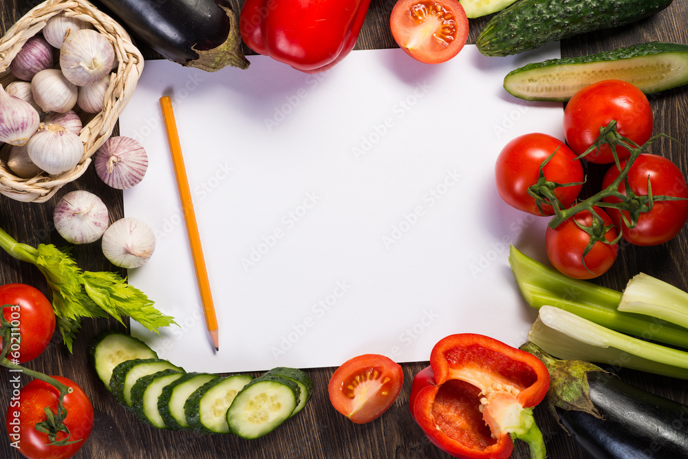 Vegetables tiled around a sheet of paper