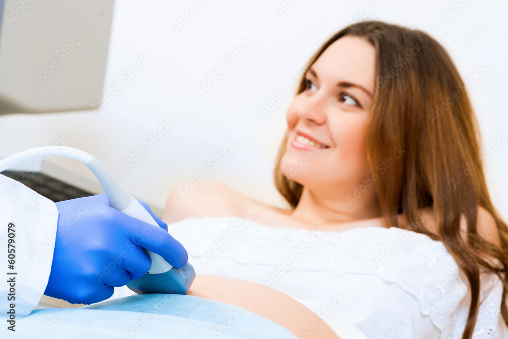 close-up of hands and abdominal ultrasound scanner