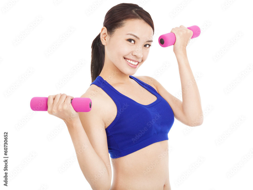 smiling woman working out with dumbbells in her hands