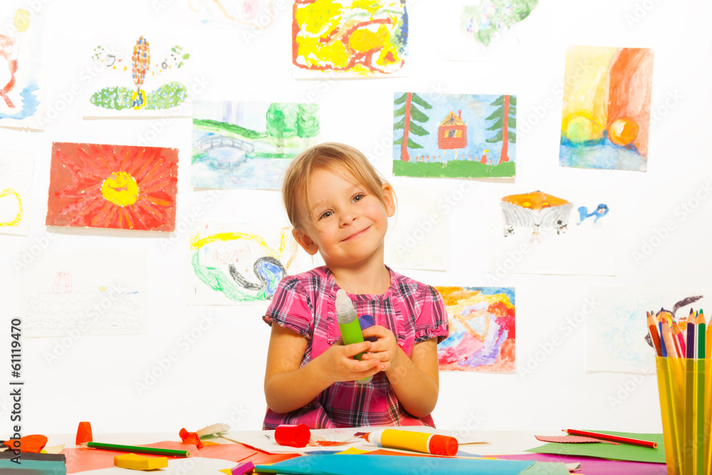 Smiling girl with glue stick