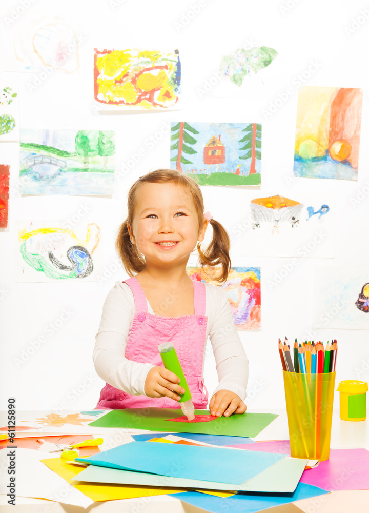 Little girl with glue stick