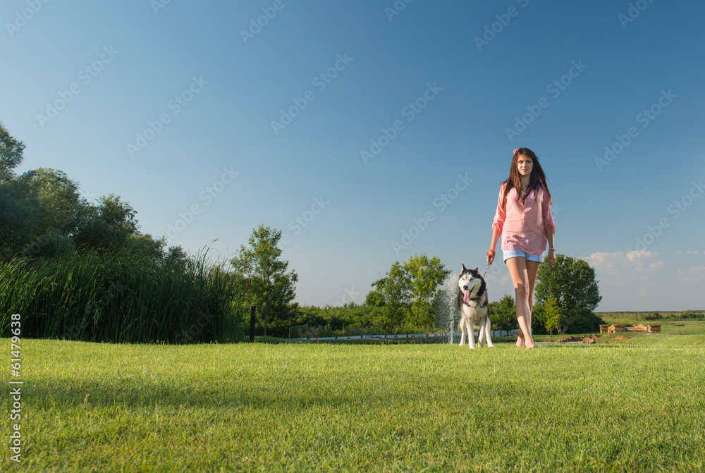 girl walking dog