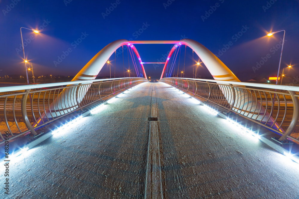 Foothpath bridge over bypass of Gdansk at night, Poland