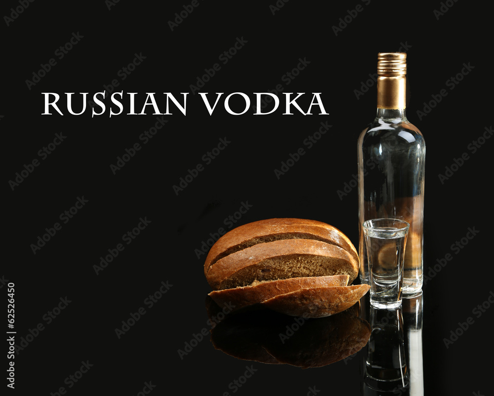 Bottle of vodka, fresh bread and glasses isolated on black