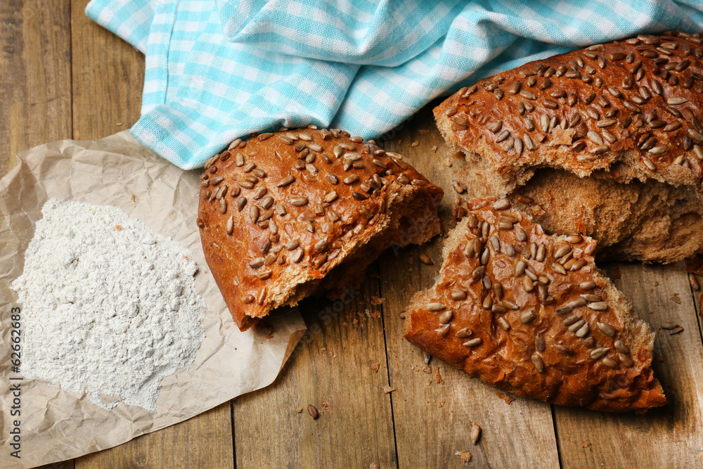 Breaking bread on wooden table