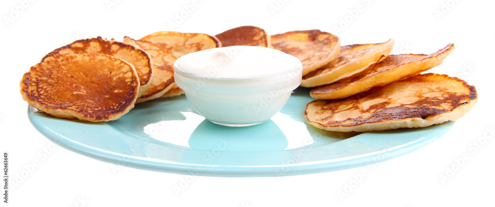 Fried pancakes on color plate, isolated on white