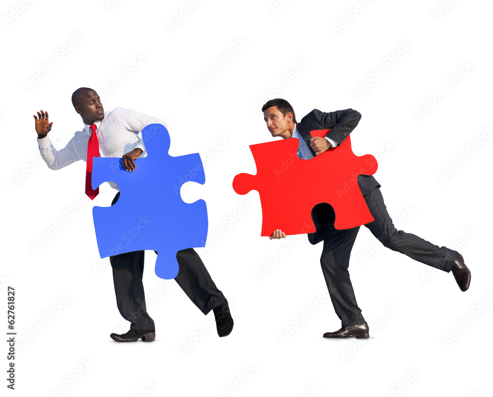 Two Businessmen Running With Jigsaw Puzzle