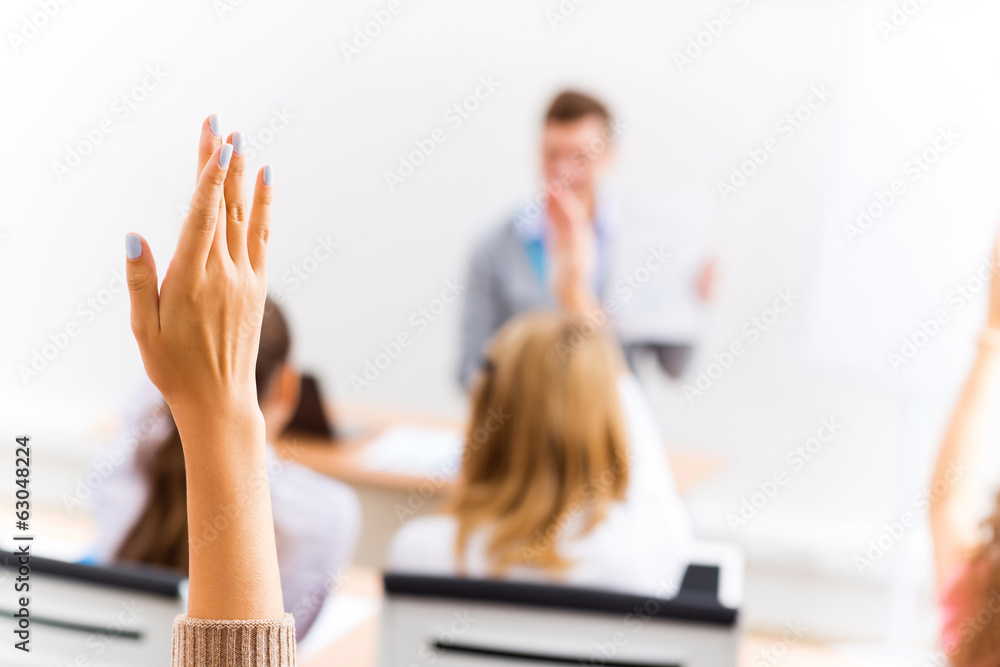 female hand raised in class