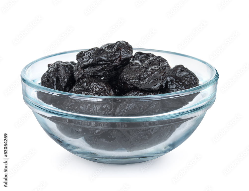 Some prunes in plate isolated on white