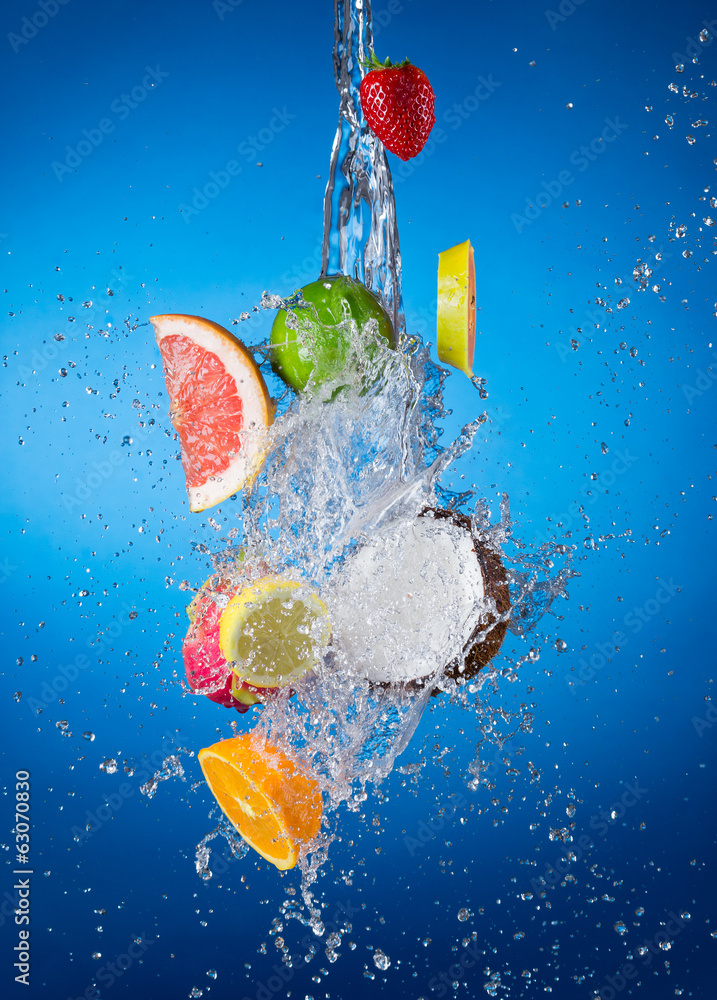 Pieces of exotic fruit in water splash