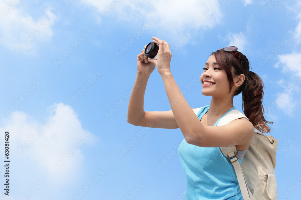 Happy woman traveler photo by camera