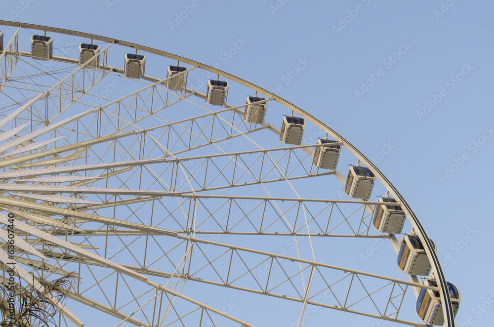 Beautiful large Ferris wheel. And the blue sky.