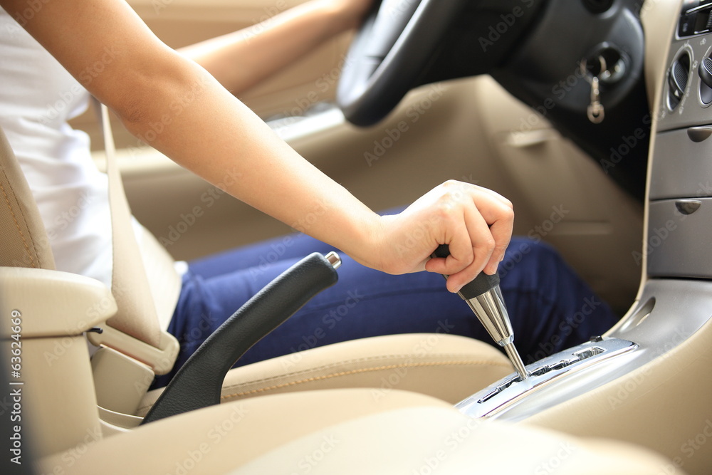 woman driver shift gear stick driving a car