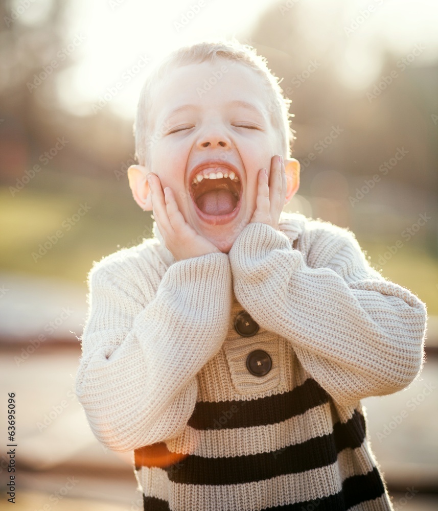 Smiling child portrait of little boy playing