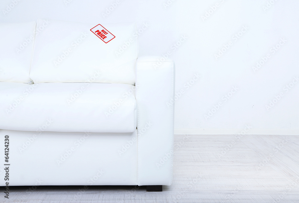 New white sofa with price on light background