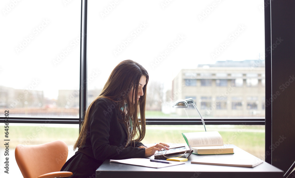 Female students finding information on tablet PC for her study