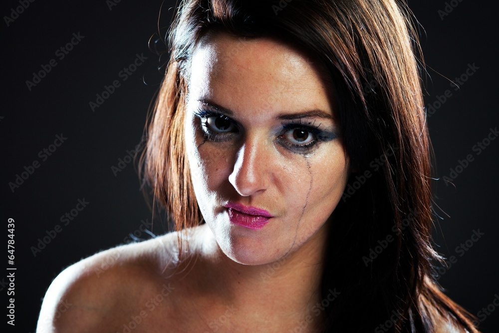 Angry and hurt woman crying, smeared make up