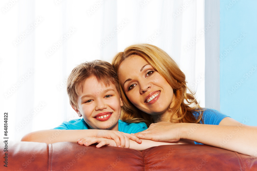 Happy mother and son hugging at home