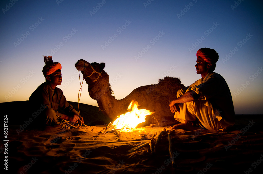 Indigenous Indian Men Resting By The Bonfire With Their Camel