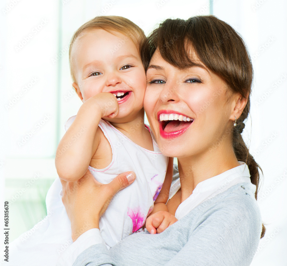 Mother and baby kissing and hugging at home