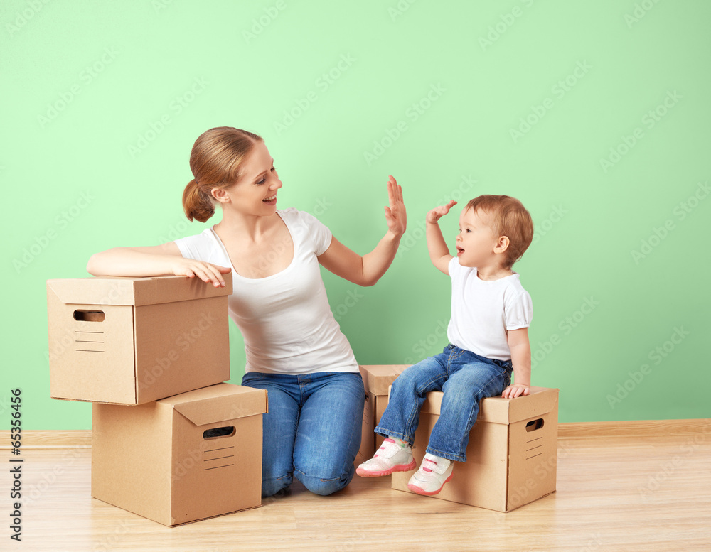 happy family mother and baby daughter in an empty apartment with