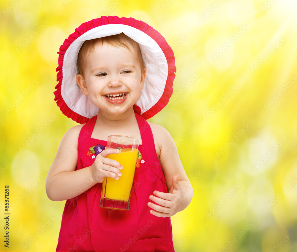 baby girl drinking orange juice in the summer