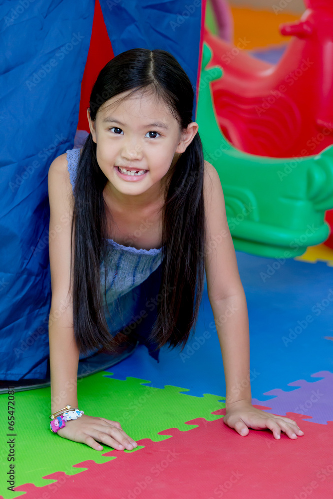 Little Asian girl play hide and seek in toy tent