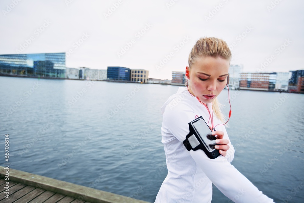 Female jogger monitor her progress on smartphone