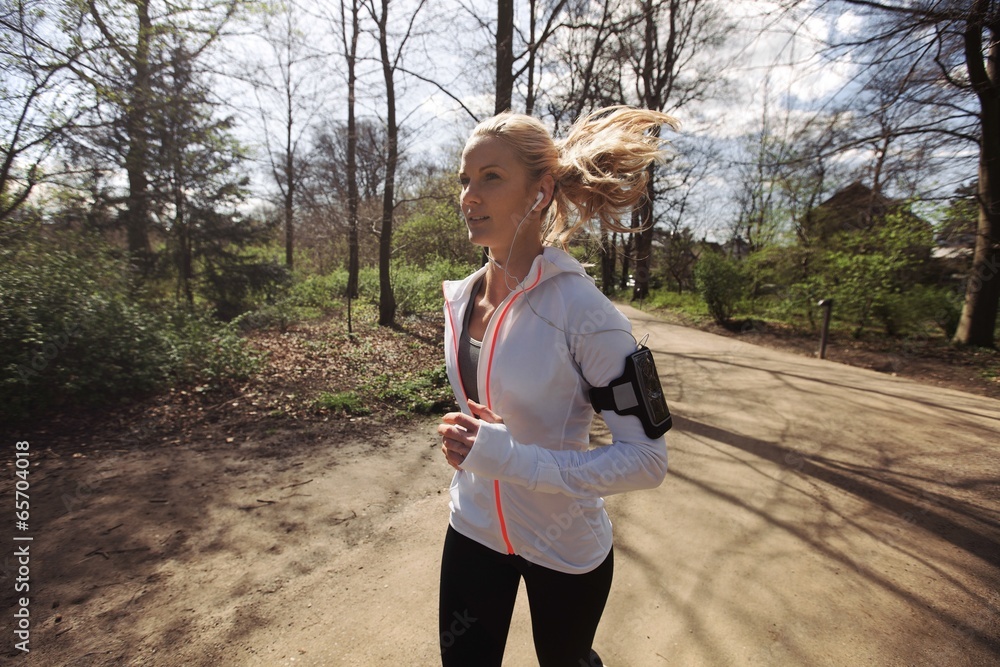 Fitness woman running in park