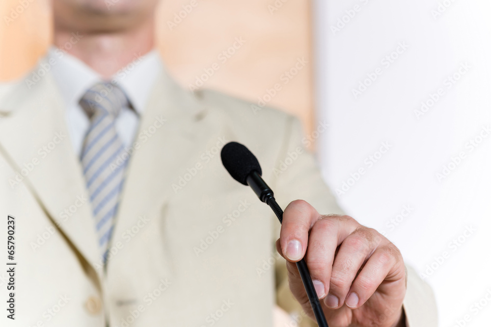 mans hand holding a microphone