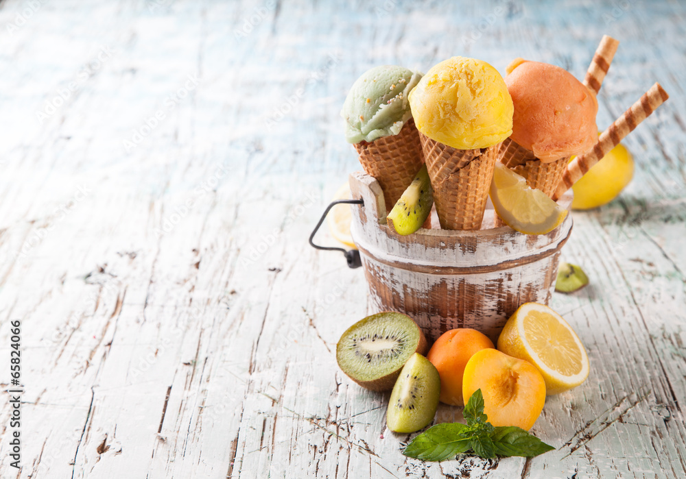 Fresh ice cream scoops in cones on wood