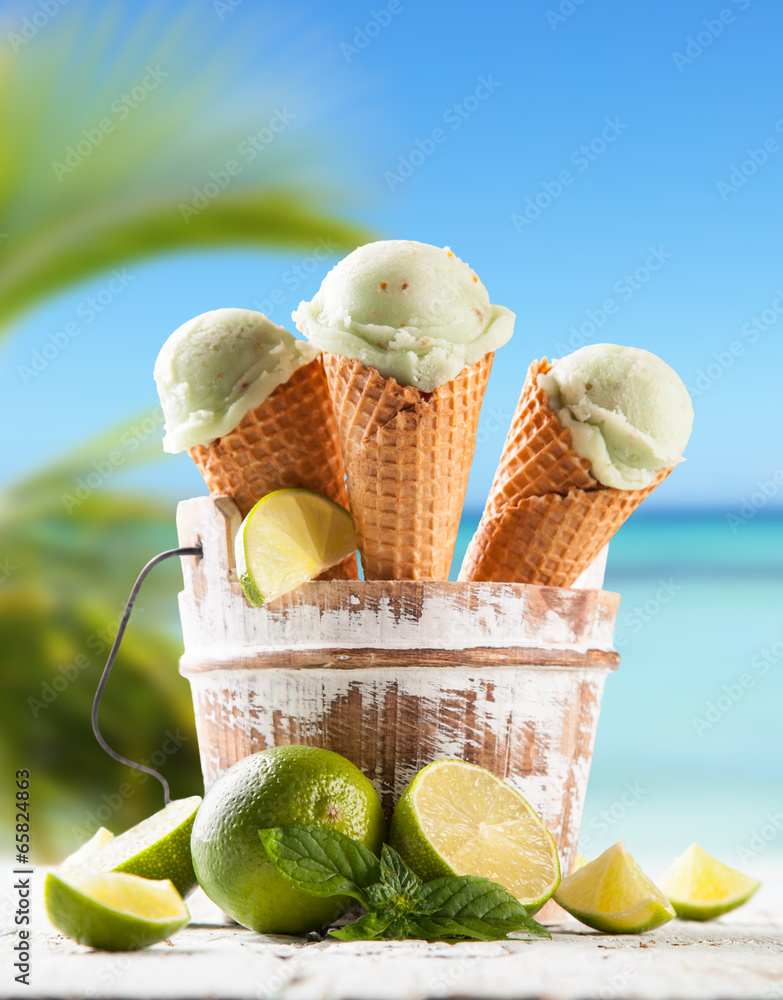 Lime ice cream scoops in cones with blur beach