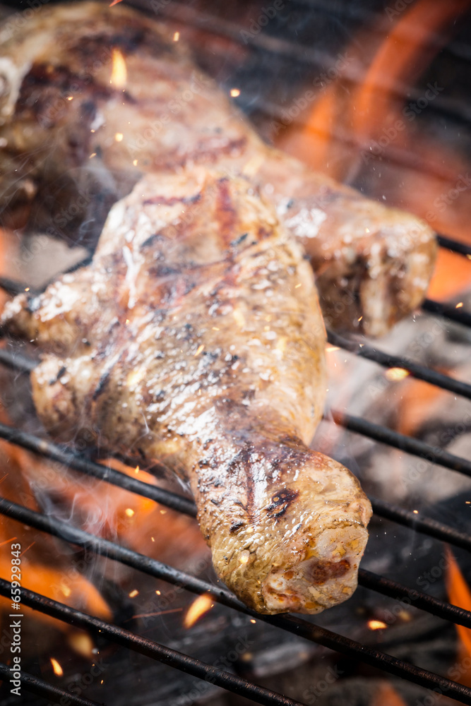 Grilled chicken leg on fire