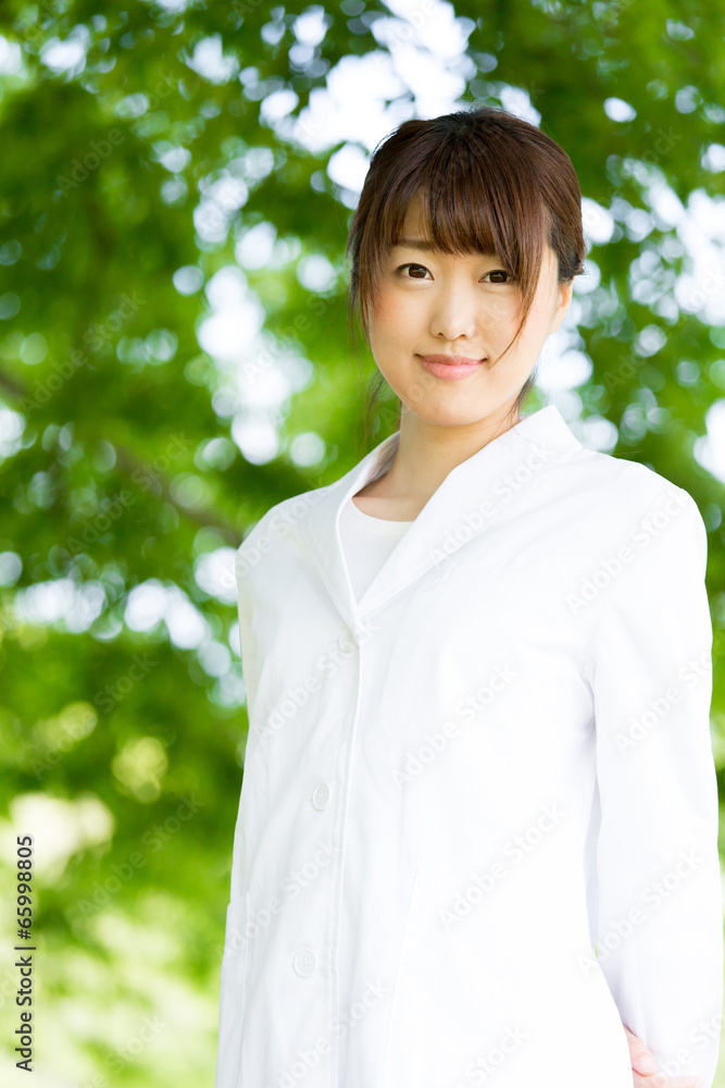 young asian doctor relaxing on green background