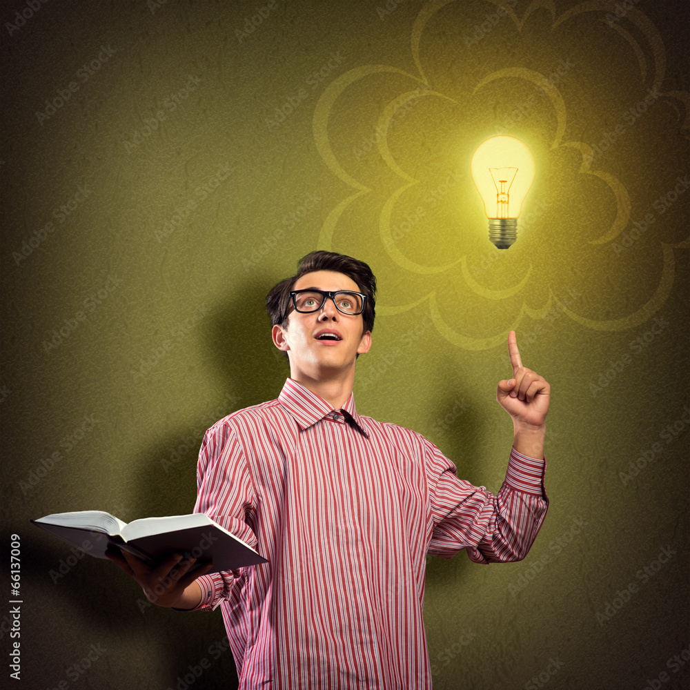 young man holding a book