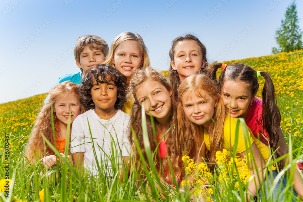 Portrait of happy children together on the grass