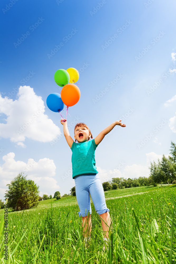 Small girl with emotions and colorful balloons